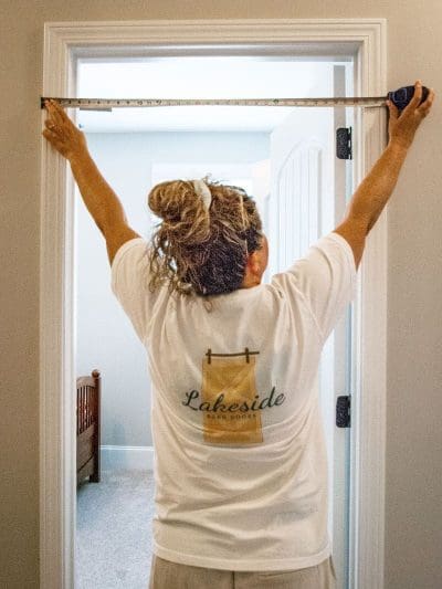 Measure the width of the door from trim to trim.